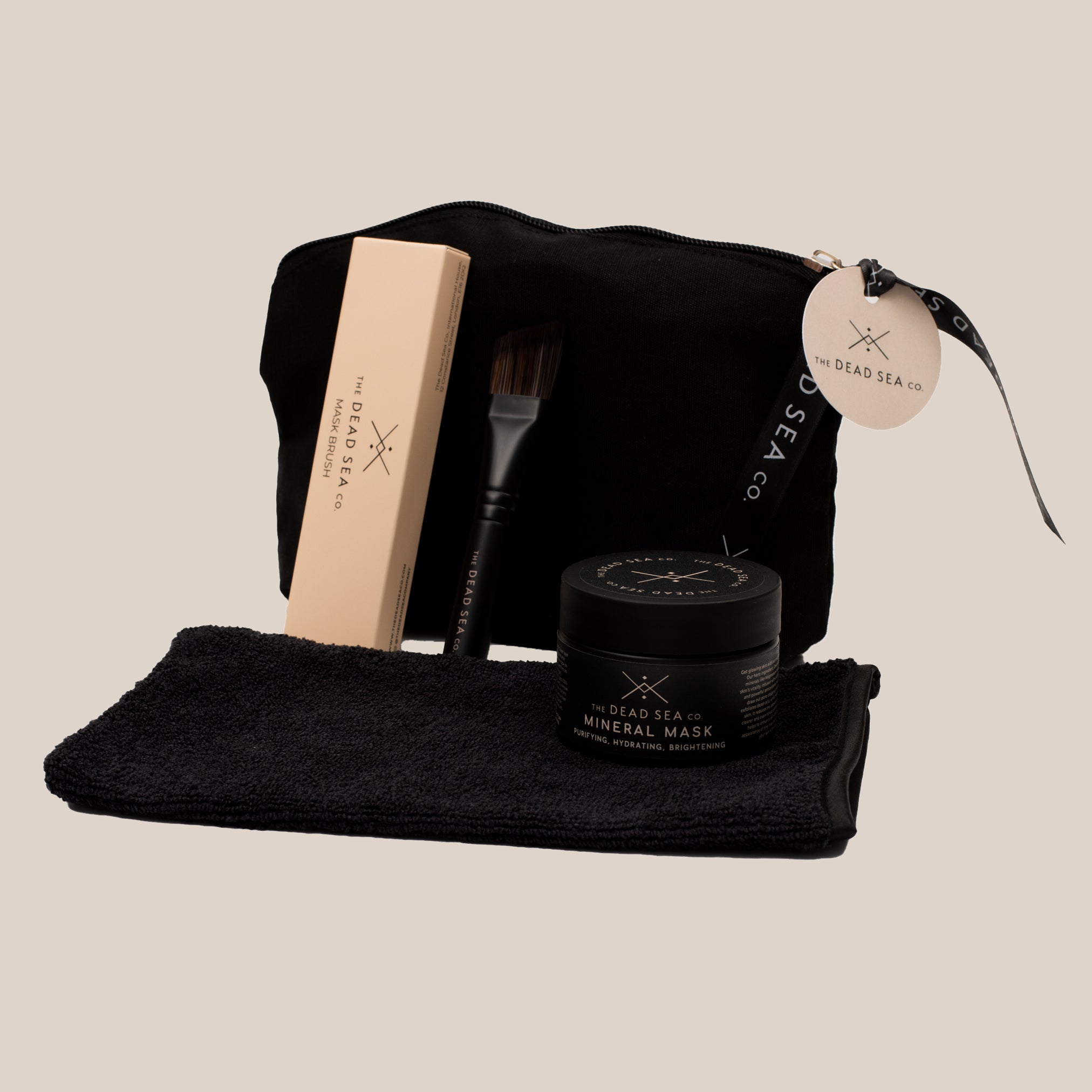 4-piece self-care ritual set, featuring a 3-in-1 face mask, brush, mitt, and wash bag for a luxurious at-home spa experience.