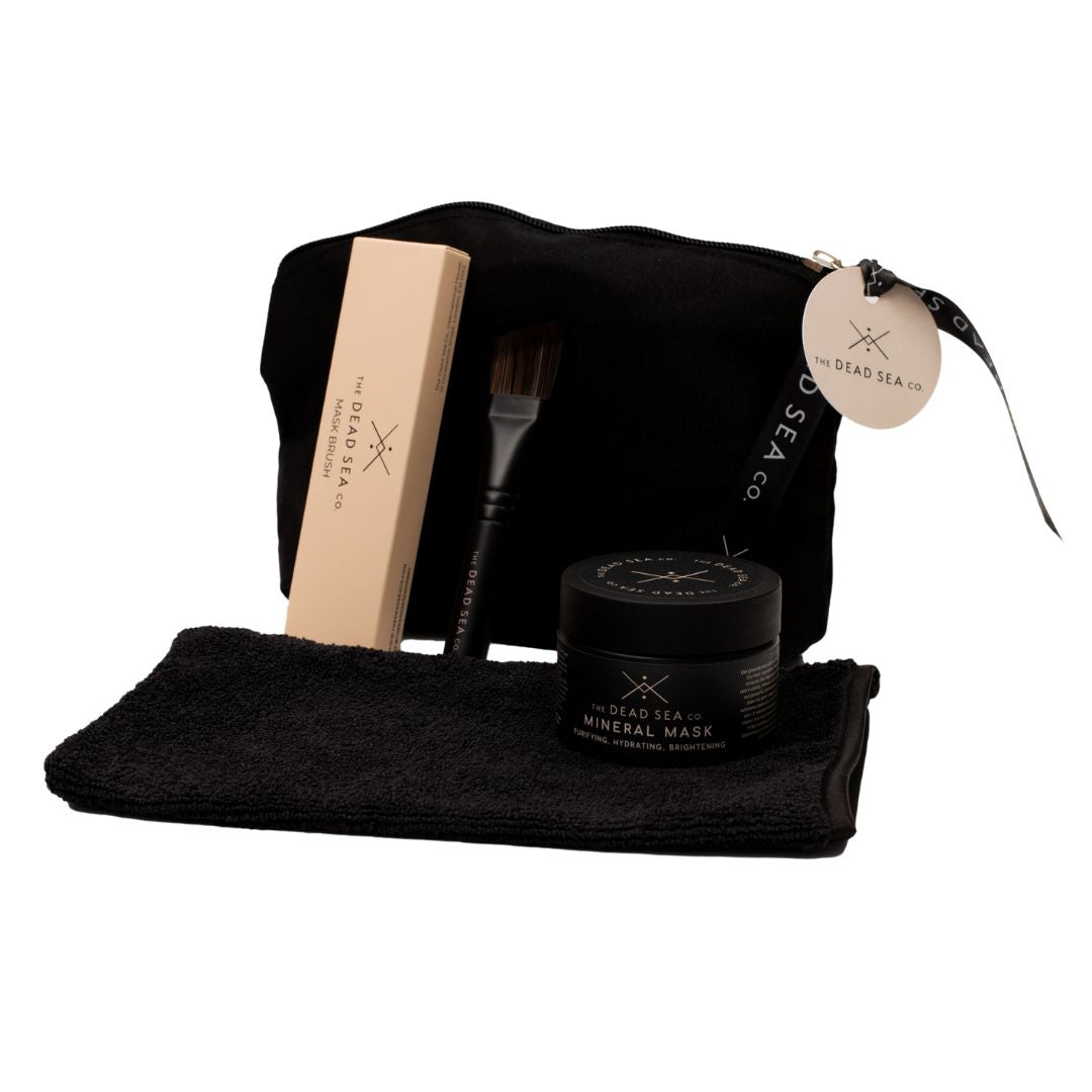 4-piece self-care ritual set, featuring a 3-in-1 face mask, brush, mitt, and wash bag for a luxurious at-home spa experience.