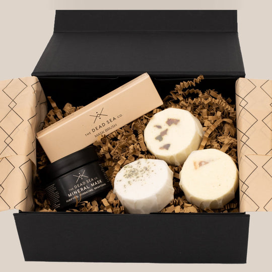 Glow & Relax Spa Bundle in an elegant gift box, featuring Dead Sea Mineral Mud Mask, brush, and three customisable aromatherapy shower steamers.